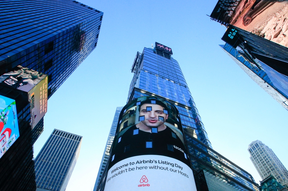 The Airbnb logo is displayed on the Nasdaq digital billboard in Times Square in New York on December 10, 2020. Photo by Kena Betancur / AFP