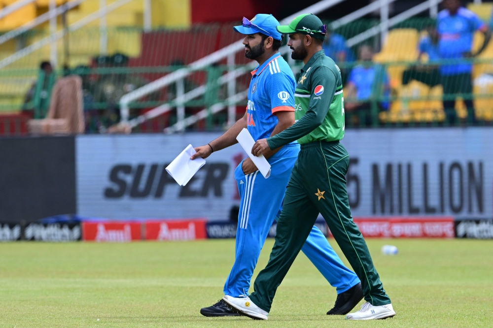 India's captain Rohit Sharma (L) and Pakistan's captain Babar Azam arrive for the toss before the start of the Asia Cup 2023 at the R. Premadasa Stadium in Colombo on September 10, 2023. (Photo by Ishara S. Kodikara / AFP)