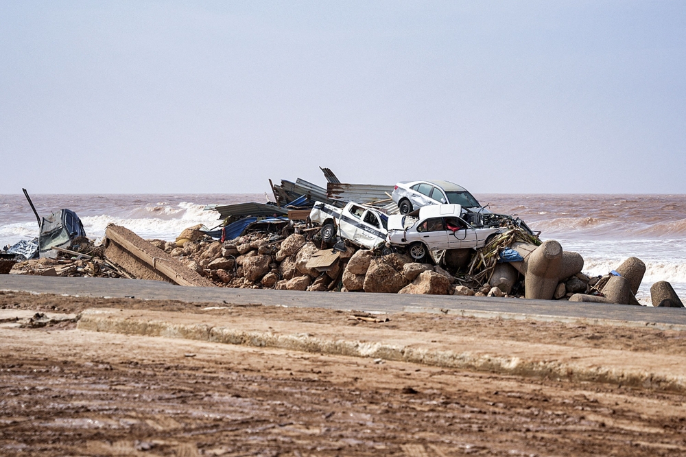 This handout picture provided by the office of Libya's Benghazi-based interim prime minister on September 11, 2023 shows a view of vehicles piled up along the side of a coastal road in the eastern city of Benghazi in the wake of the Mediterranean storm 