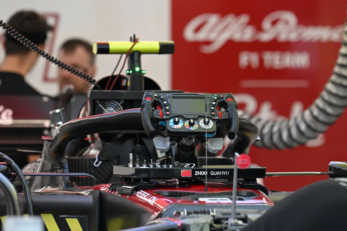 Mechanics work on the car of Alfa Romeo's Chinese driver Zhou Guanyu ahead of the Singapore Formula One Grand Prix night race at the Marina Bay Street Circuit in Singapore on September 14, 2023. (Photo by MOHD RASFAN / AFP)