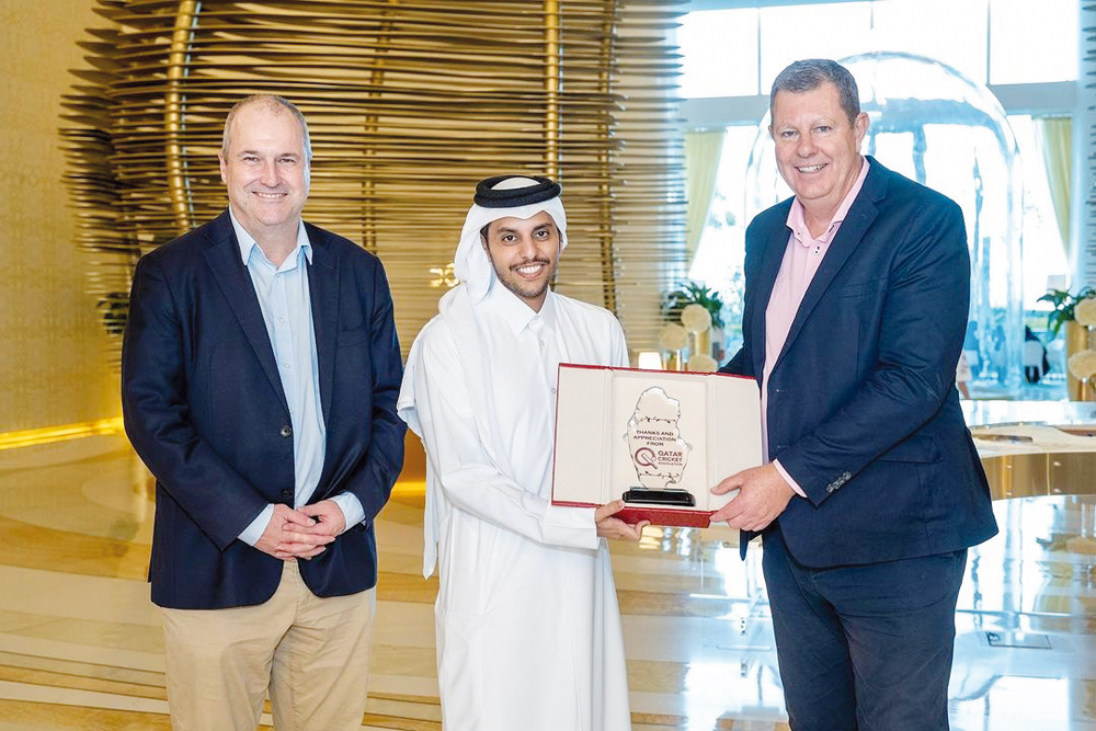 Qatar Cricket Association President Sheikh Abdulaziz Saoud Al Thani presents a memento to ICC Chairman Greg Barclay as ICC CEO Geoffrey Allardice (left) looks on.