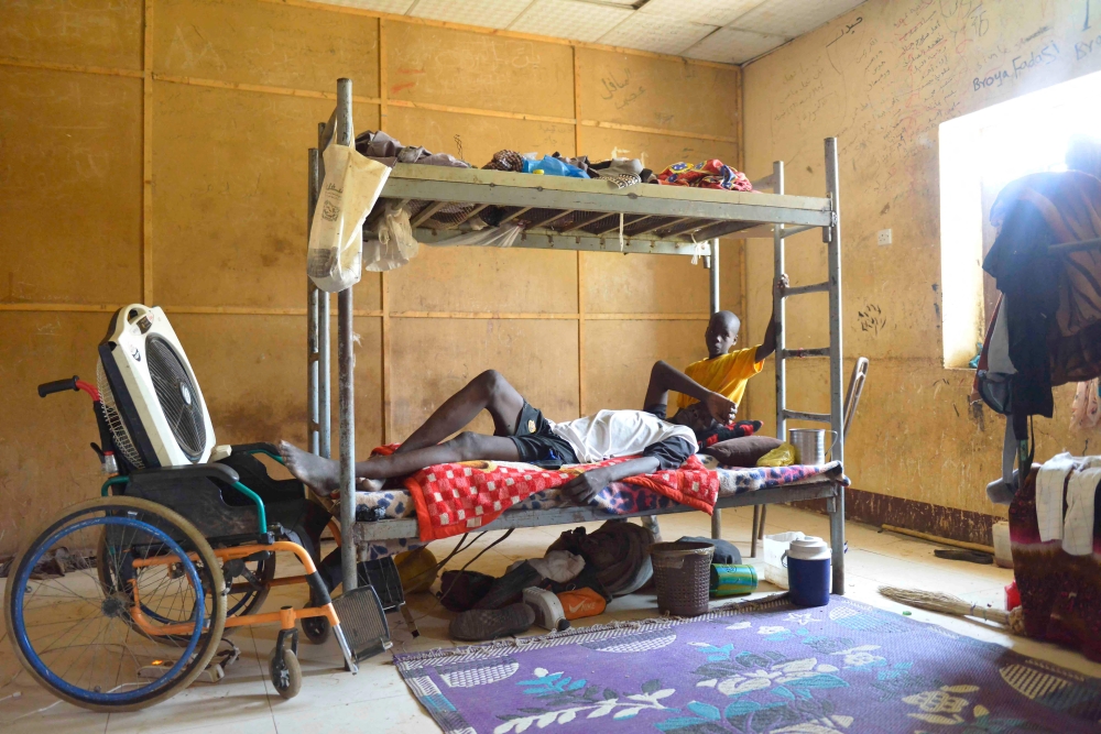 File photo: Displaced people who fled the ongoing violence by two rival Sudanese generals, sit in a room inside the university of al-Jazira, transformed into a makeshift shelter, in al-Hasaheisa south of Khartoum on July 8,2023. (AFP)