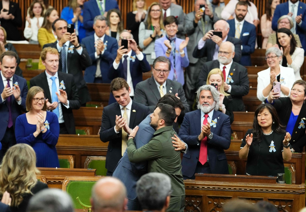 Ukrainian President Volodymyr Zelensky (right) receives a hug from Canadian Prime Minister Justin Trudeau after addressing the House of Commons in Ottawa, Canada, on September 22, 2023. (Photo by Sean Kilpatrick / POOL / AFP)