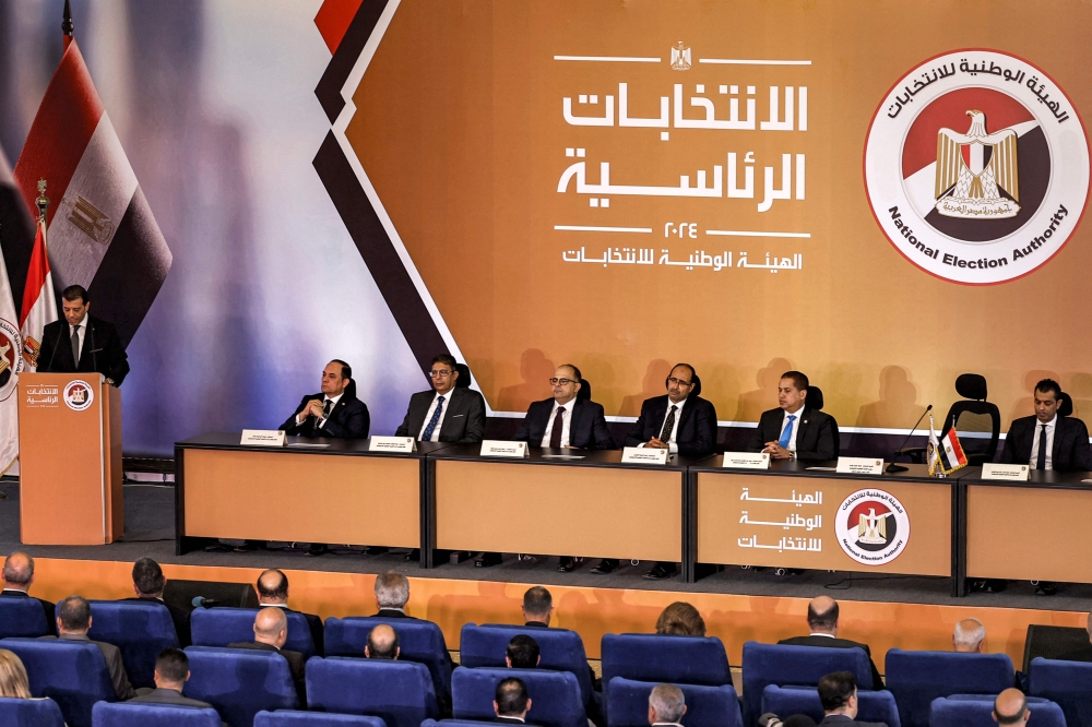 Judge Walid Hassan Hamza (L), Chairman of Egypt's National Election Authority (NEA) and Vice President of the Cassation Court, speaks during a press conference regarding the upcoming 2024 Egyptian Presidential Elections at the Cairo International Convention Centre in Cairo on September 25, 2023. (Photo by Khaled DESOUKI / AFP)
