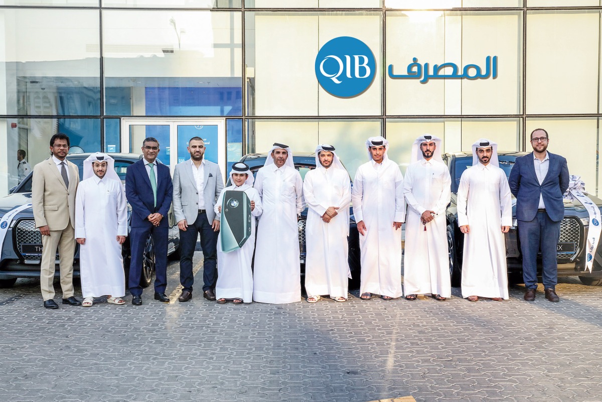 QIB and Visa officials pose for a group photo with the winners.