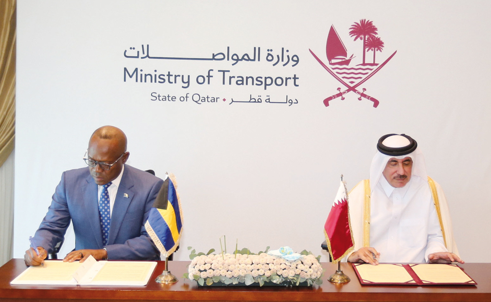 Minister of Transport H E Jassim Saif Ahmed Al Sulaiti and Deputy Prime Minister and Minister of Tourism, Investments and Aviation of the Bahamas, H E Isaac Chester Cooper signing the agreement. 