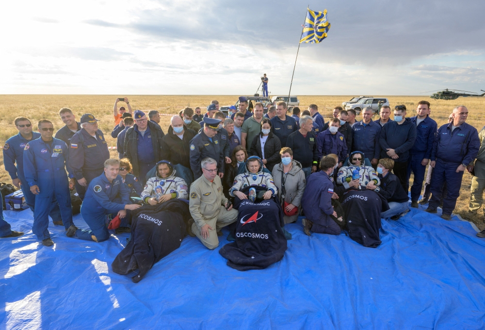 A handout photograph taken and released by NASA on September 27, 2023, shows International Space Station (ISS) crew (From L-Bottom) Expedition 69 NASA astronaut Frank Rubio, Roscosmos cosmonauts Sergey Prokopyev and Dmitri Petelin (sitting in chairs) after its' landing in a remote area near the town of Dzhezkazgan, Kazakhstan. (Photo by Bill Ingalls / NASA / AFP) 