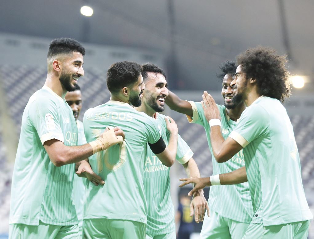 Al Sadd players celebrate after Ali Asad’s (centre) goal against Al Gharafa yesterday.    