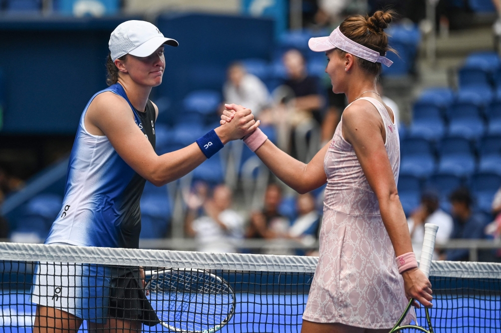 Iga Swiatek of Poland (L) shakes hands with winner Veronika Kudermetova of Russia (R) after their women's singles quarter-final match on day five of the Pan Pacific Open tennis tournament in Tokyo on September 29, 2023. Photo by Richard A. Brooks / AFP