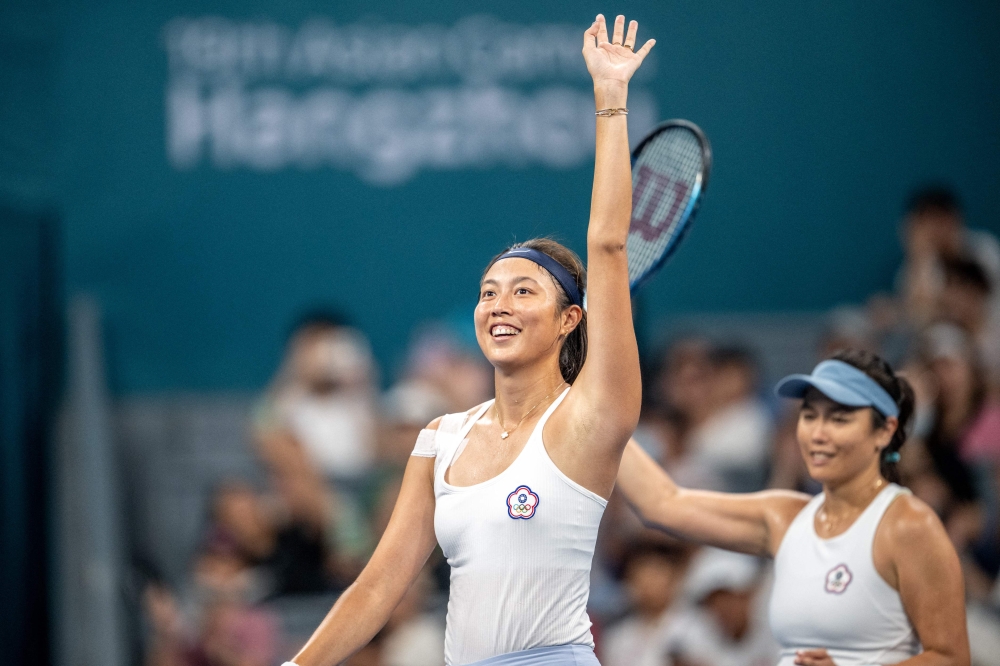 Taiwan's Chan Hao-ching (L) and Chan Yung-jan celebrate their win against Taiwan's Lee Ya-hsuan and Liang En-shuo during their Hangzhou 2022 Asian Games women's double final tennis match. (Photo by Philip FONG / AFP)