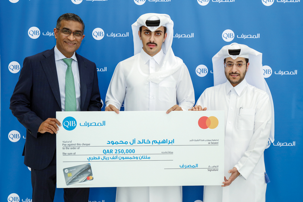 Officials pose with the winner of Summer Spends campaign 2023.