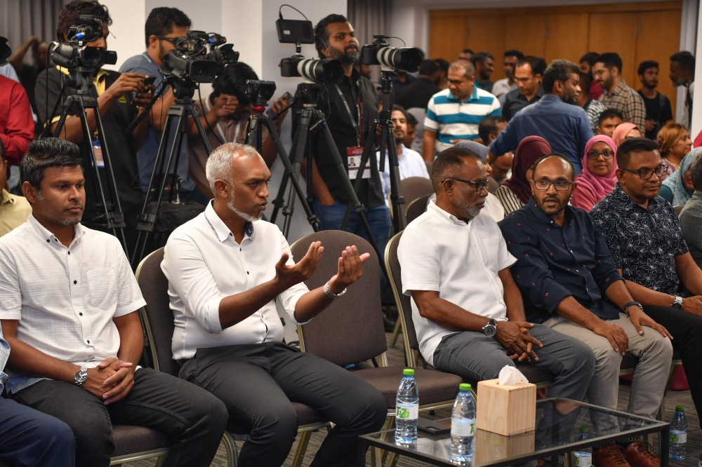 People's National Congress (PNC) candidate Mohamed Muizzu (2nd L) gestures during a press conference in Male, on September 30, 2023. (Photo by Mohamed Afrah / AFP)
