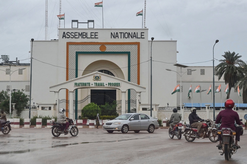 File photo: Motorists drive past the National Assembly in Niamey on August 7, 2023. (Photo by AFP)

