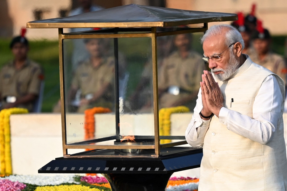 India's Prime Minister Narendra Modi pays respect on the occasion of Mahatma Gandhi's birth anniversary at his memorial in Rajghat, in New Delhi on October 2, 2023. (Photo by Sajjad Hussain / AFP)
