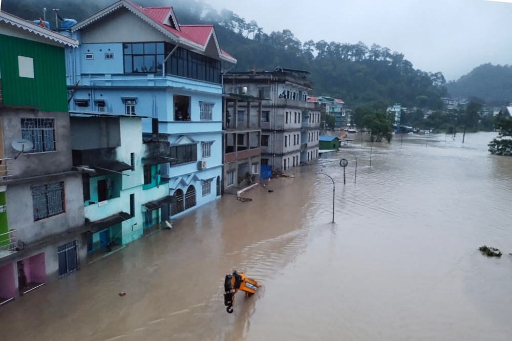 This handout photograph released by the Indian Army and taken on October 4, 2023, shows a flooded street in Lachen Valley, in India's Sikkim state following a flash flood caused by intense rainfall. (Photo by Indian Army / AFP) 