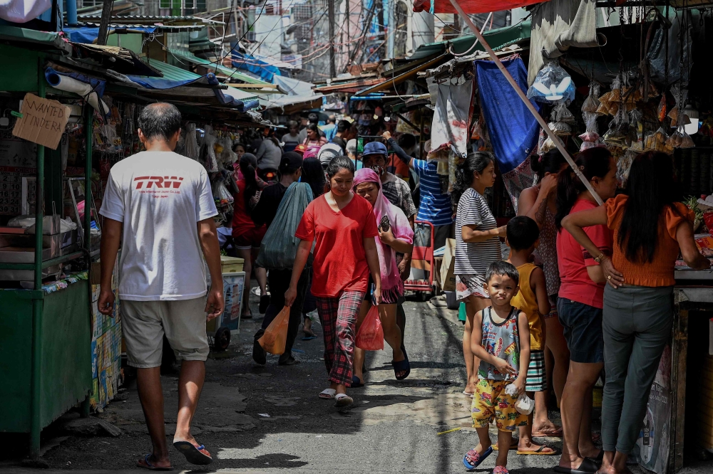 People visit a market in Manila on October 5, 2023. (Photo by JAM STA ROSA / AFP)