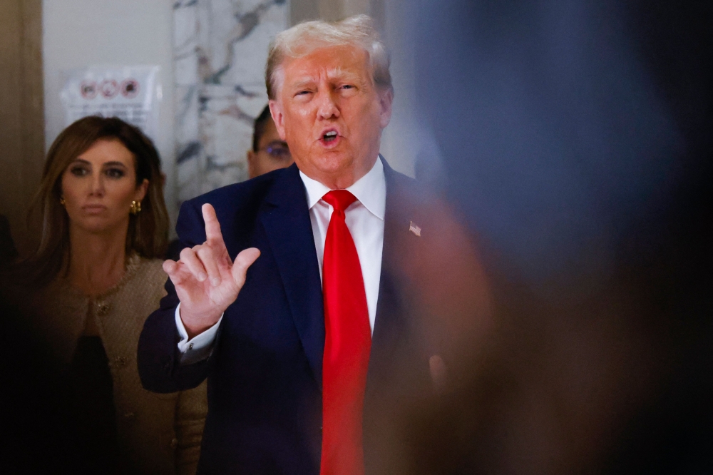 Former US President Donald Trump speaks to members of the media during the third day of his civil fraud trial in New York on October 4, 2023. (Photo by KENA BETANCUR / AFP)
