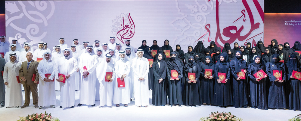 Prime Minister and Minister of Foreign Affairs H E Sheikh Mohammed bin Abdulrahman bin Jassim Al Thani and Minister of Education and Higher Education H E Buthaina bint Ali Al Jabr Al Nuaimi with top-performing and long-serving teachers on the occasion of World Teachers' Day yesterday. 