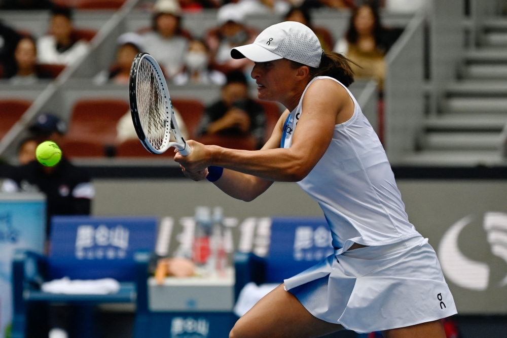 Poland Iga Swiatek hits a return to France's Caroline Garcia during their women singles quarter-final match of the WTA China Open tennis tournament in Beijing on October 6, 2023. Photo by Pedro PARDO / AFP