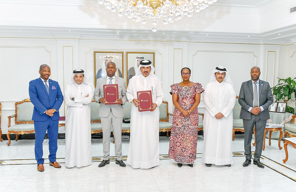 Minister of Commerce, Transport, Industry, and Tourism of Burundi, H E Marie Chantal Nijimbere and QC First Vice-Chairman Mohamed bin Twar Al Kuwari with other officials pose for a group photo. 