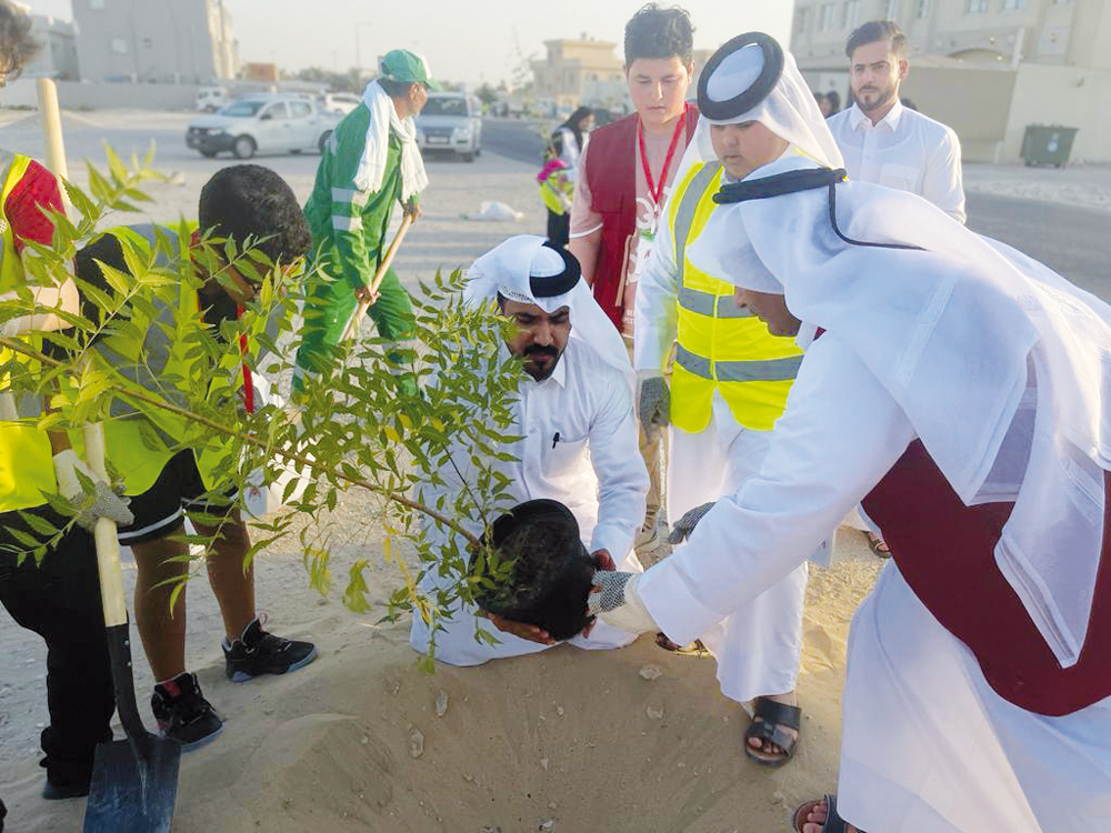 Members of the youth body at Al Rayyan Club planting trees. 