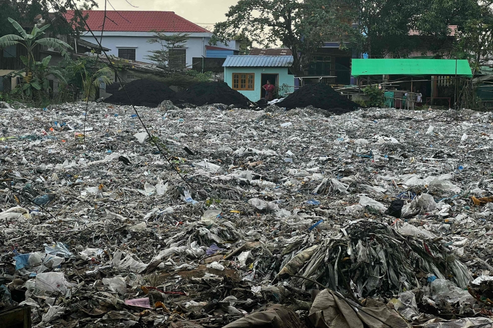 This photo taken on October 11, 2023 shows plastic waste in Yangon's Shwepyithar township. In a working-class neighbourhood of Myanmar's Yangon, plastic waste is piled a metre high, the toxic product of what a recent investigation says is rampant dumping of Western trash. (Photo by AFP) 