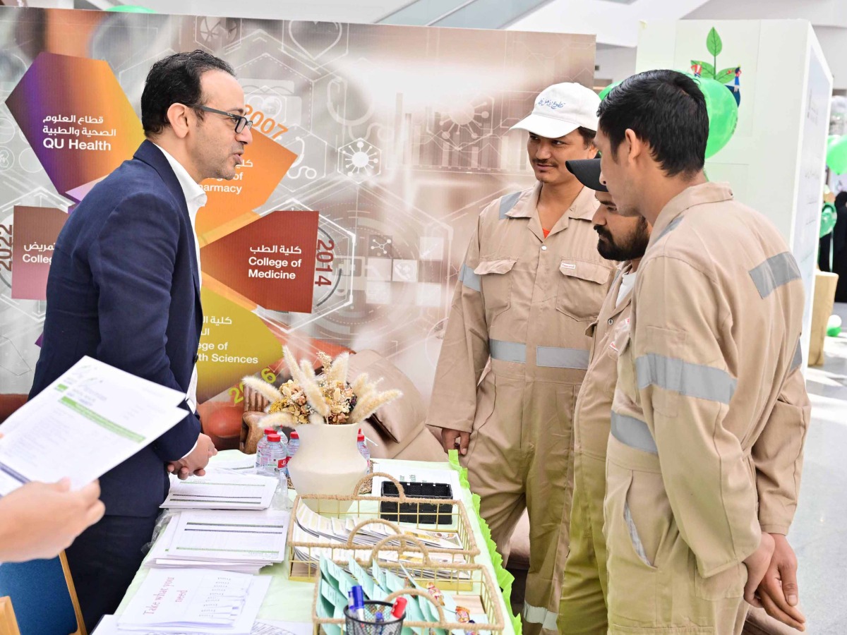 Dr. Ehab Hamed, Family Medicine Consultant and Physician at QU Health Center educating some workers during the event.