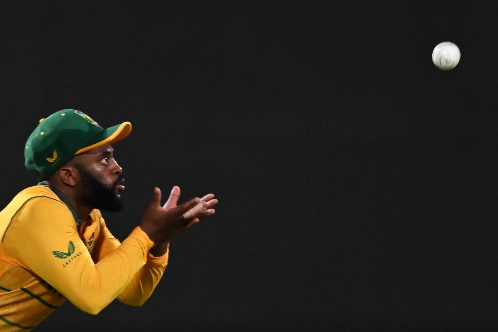 (FILES) In this file photo taken on June 09, 2022 South Africa's captain Temba Bavuma takes the catch to dismiss India's Ruturaj Gaikwad (not pictured) during the first Twenty20 international cricket match between India and South Africa at the Arun Jaitley Stadium in New Delhi. 
