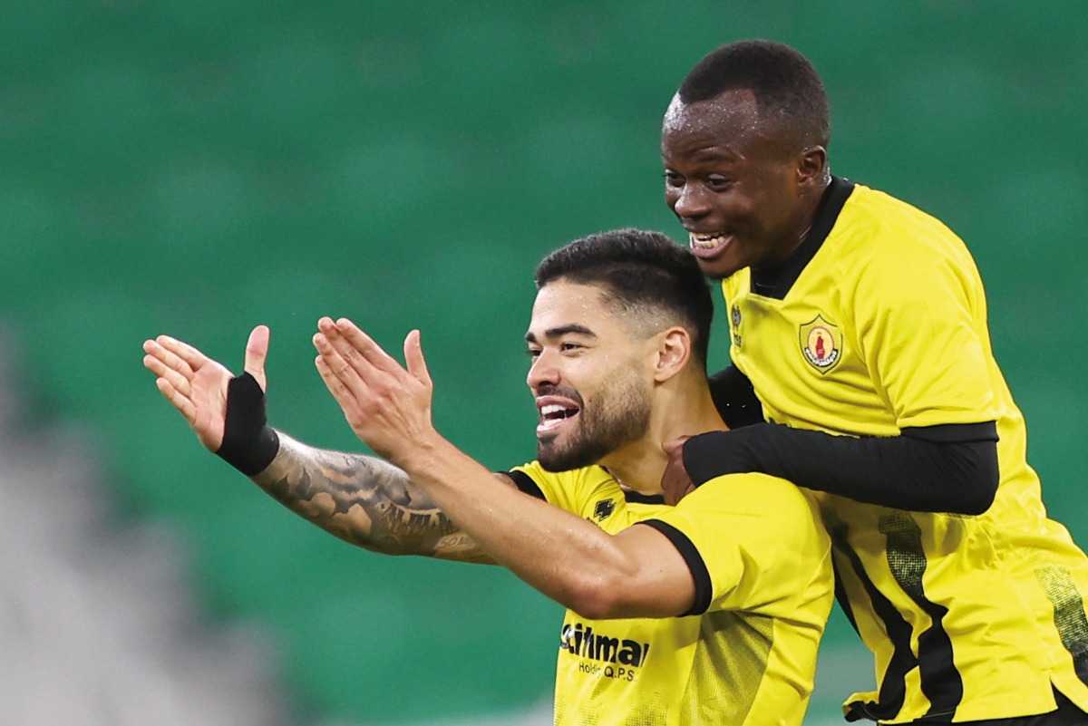 Qatar SC's Bruno Tabata (left) celebrates with Raoul Sanda after scoring a goal. Pic: Mohamed Farag