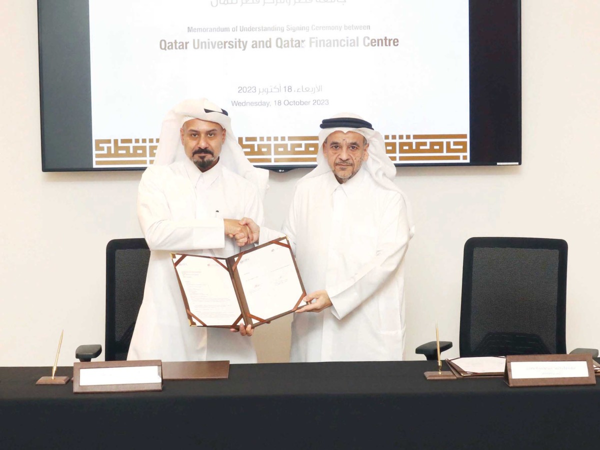 QU President Dr. Omar Al Ansari and Chief Executive Officer of QFC Yousuf Mohamed Al Jaida (left) during the MoU signing.