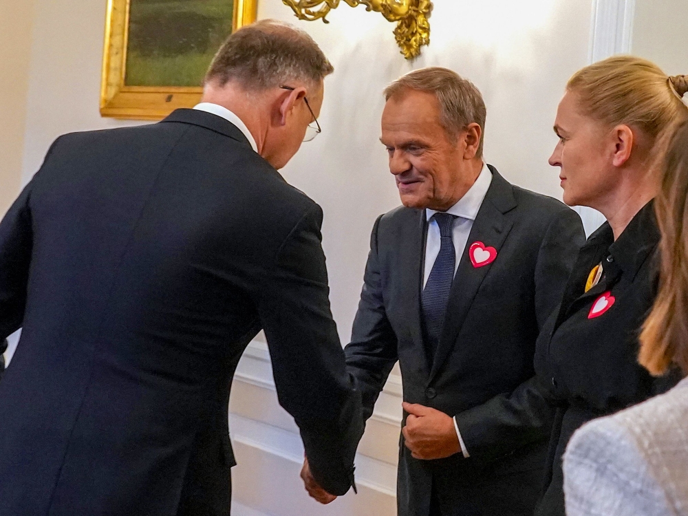 Polish President Andrzej Duda (L) meets with leaders of Civic Coalition Donald Tusk, and Barbara Nowacka for talks about the creation of a new government, on October 24, 2023 in Warsaw, Poland, following the October 15 parliamentary election. (Photo by JANEK SKARZYNSKI / AFP)
