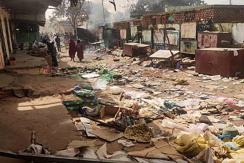 File Photo: People walk among scattered objects in the market of El Geneina, the capital of West Darfur on April 29, 2023. (AFP)