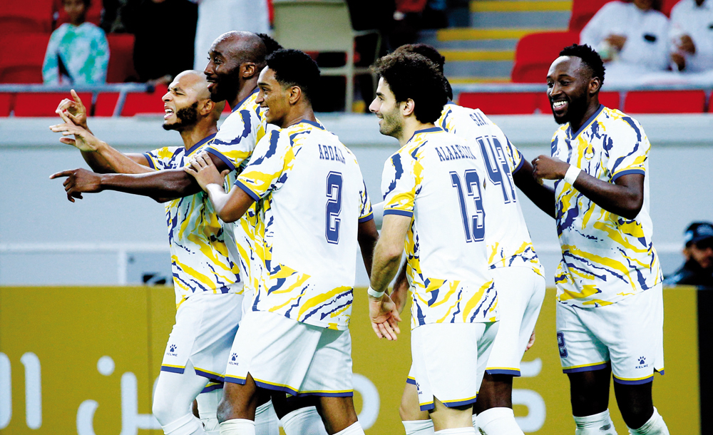 Al Gharafa's Yacine Brahimi (left) celebrates with teammates after scoring his second goal. Pic: Rajan Vadakkemuriyil
