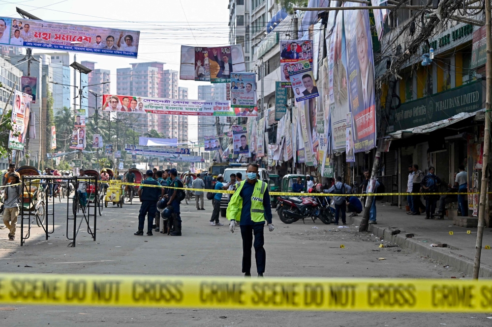 Bangladesh's Criminal Investigation Department (CID) member inspects a protest site after Bangladesh Nationalist party (BNP) activists held a rally amid the ongoing nationwide strike in Dhaka on October 29, 2023.  (Photo by Munir Uz Zaman / AFP)