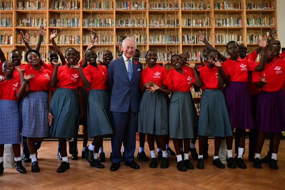 Britain's King Charles III poses for a group photo with participants of the Prince's Trust International (PTI) Enterprise Challenge during a visit to the Eastlands Library in Nairobi on October 31, 2023. (Photo by Ben Stansall / POOL / AFP)