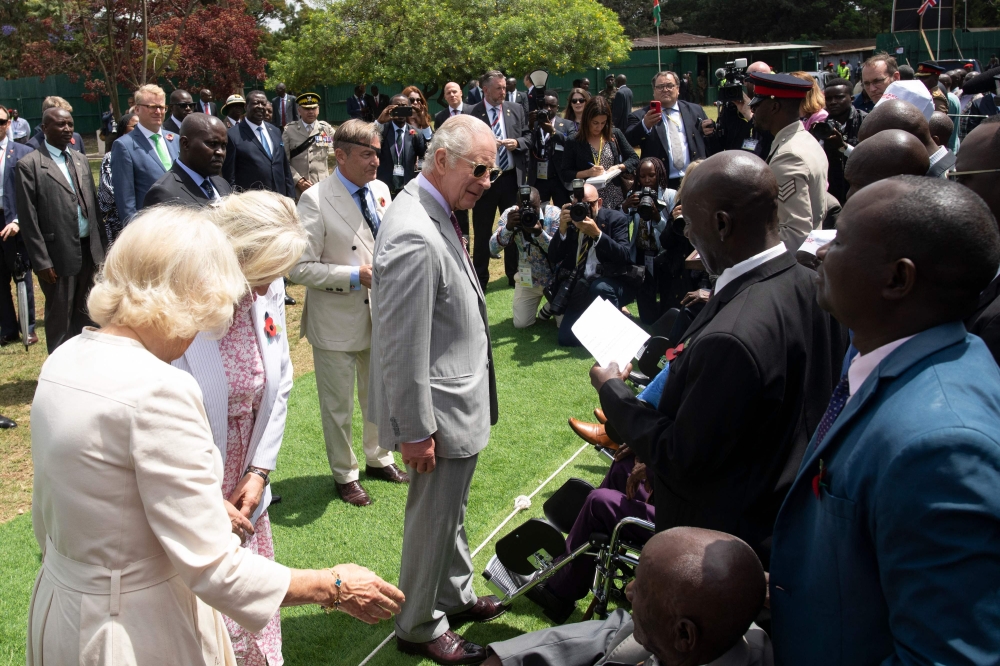 Britain's King Charles III (centre) meets Kenyan war veterans during a visit to a Commonwealth War Graves Kariokor Cemetery in Nairobi on November 1, 2023.(Photo by Tony Karumba / POOL / AFP)