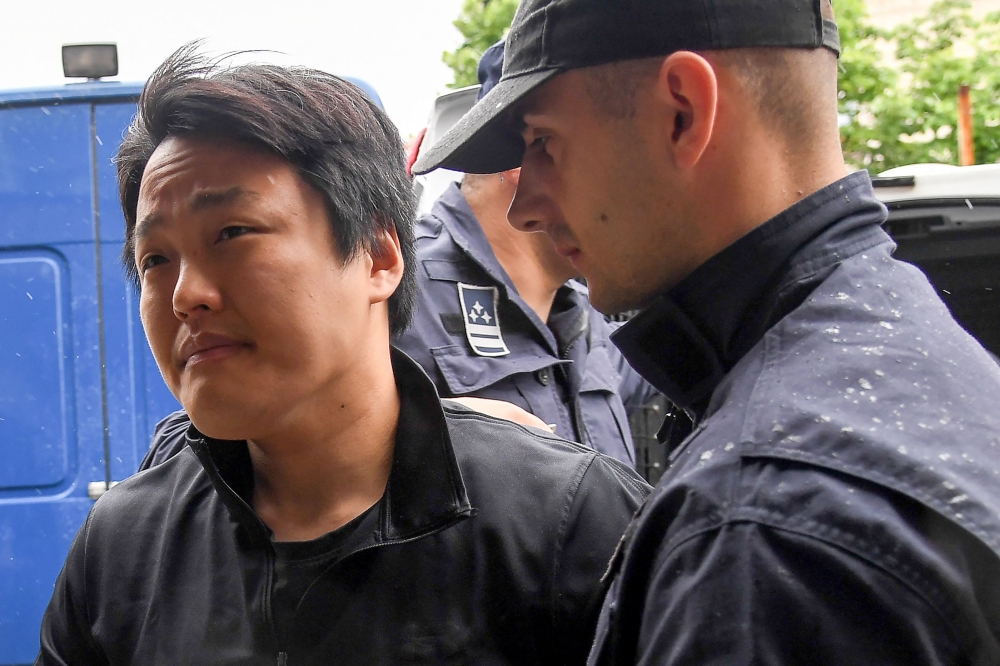 South Korean cryptocurrency entrepreneur, co-founder of Terraform Labs (Terra Luna), Do Kwon (L), is taken to court in Podgorica on May 11, 2023, following his arrest on March 24 at the Montenegrin capital's international airport. (Photo by SAVO PRELEVIC / AFP)


