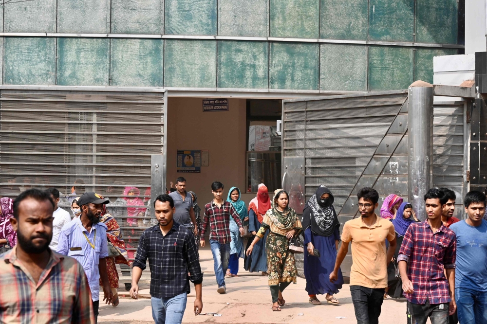 Garment workers walk off a factory at lunch break in Ashulia on November 8, 2023. (Photo by Munir uz zaman / AFP)