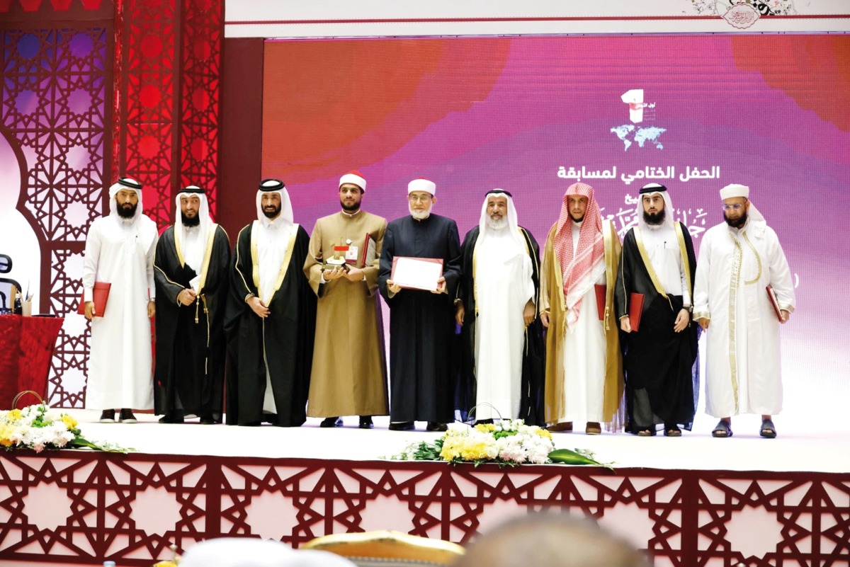 Minister of Awqaf and Islamic Affairs H E Ghanem bin Shaheen bin Ghanem Al Ghanim with officials and the winner of 'Awal Al Awail' title of the holy Quran contest.