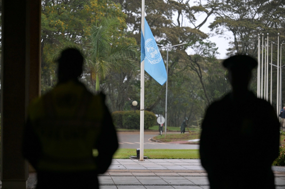 Security officials look on as the United Nations flag flies at half-mast to mourn the lives of UN workers lost during the war in Gaza, at the United Nations Office Nairobi (UNON) in Nairobi on November 13, 2023. Photo by SIMON MAINA / AFP