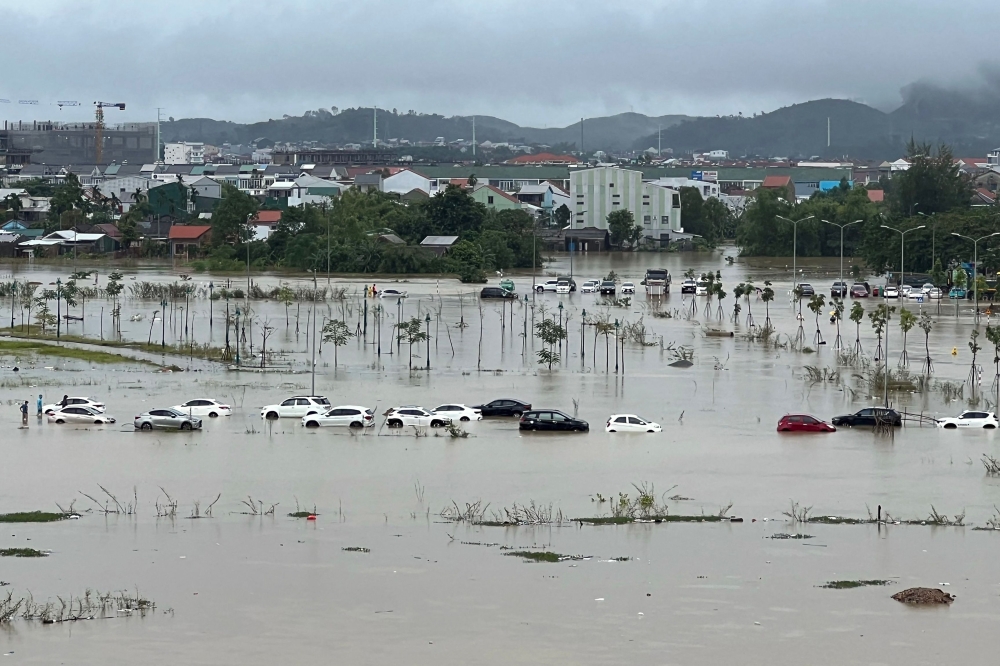 Flood waters submerge parked cars in Hue city in central Vietnam on November 15, 2023. (Photo by Hai Duong / AFP)