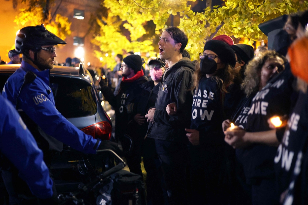 Members of US Capitol Police and protesters stand off outside the headquarters of the Democratic National Committee on November 15, 2023 on Capitol Hill in Washington, DC. Alex Wong/Getty Images/AFP 