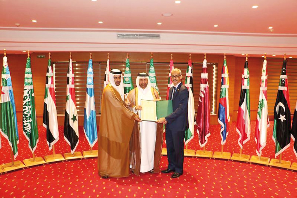 Prof Dr. Khalid bin Ibrahim Al Sulaiti, General Manager of Katara, receiving the certificate from ALESCO officials.