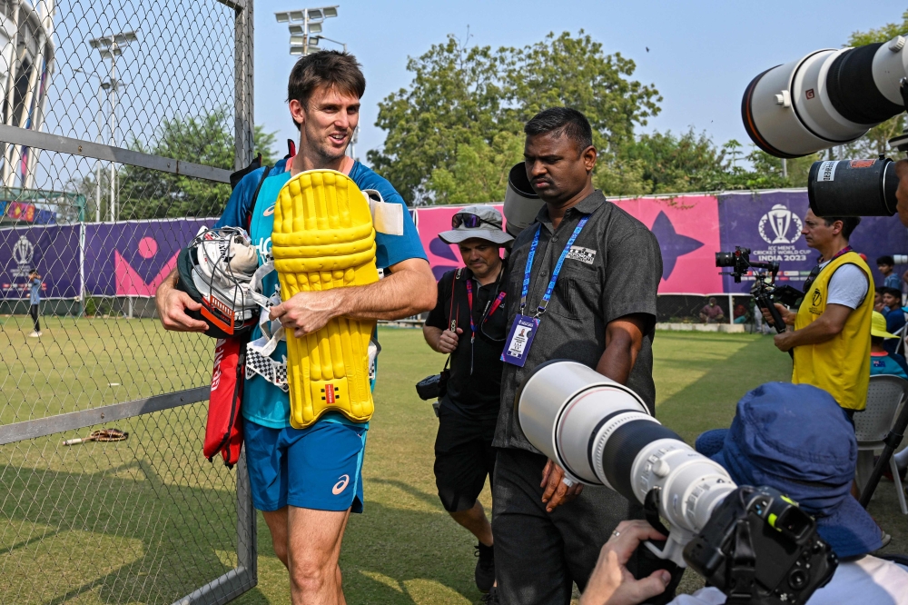 Australia's Mitchell Marsh (L) attends a practice session on the eve of their 2023 ICC Men's Cricket World Cup one-day international (ODI) final match against India at the Narendra Modi Stadium in Ahmedabad on November 18, 2023. (Photo by Punit PARANJPE / AFP)