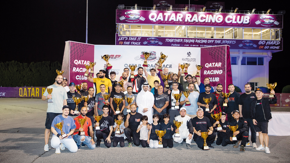 Qatar Racing Club Director Sheikh Jabor bin Khalid Al Thani poses for a photograph with the podium winners.