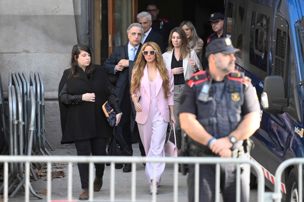 Colombian singer Shakira (C) leaves the High Court of Justice of Catalonia after attending her trial on tax fraud, in Barcelona on November 20, 2023. (Photo by Josep Lago / AFP)