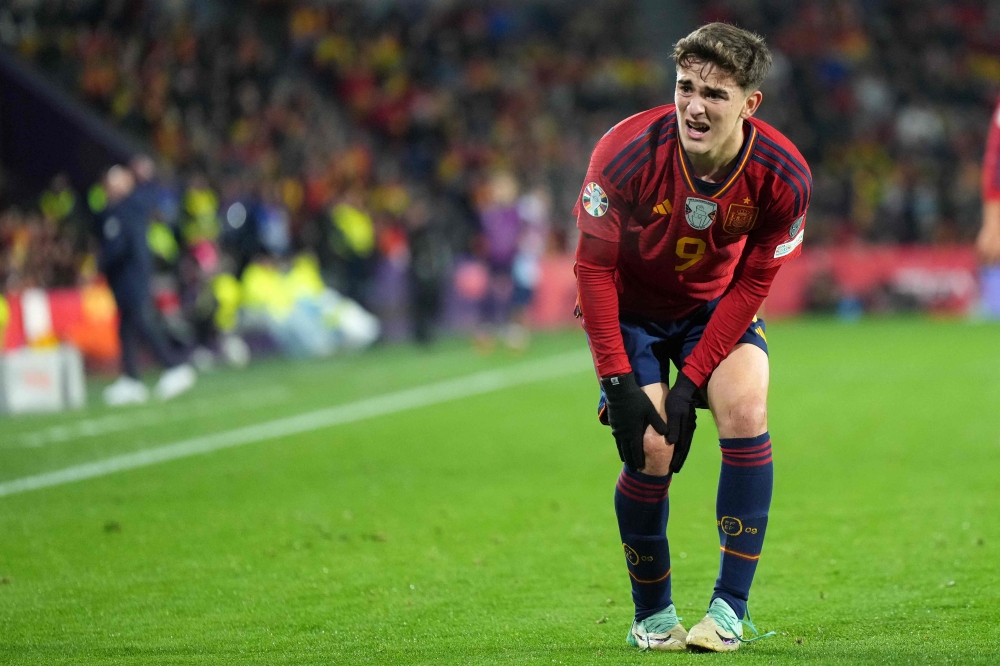 Spain's midfielder #09 Gavi reacts to injuring his knee during the UEFA Euro 2024 group A qualifying football match between Spain and Georgia at the Jose Zorrilla stadium in Valladolid on November 19, 2023. Photo by CESAR MANSO / AFP