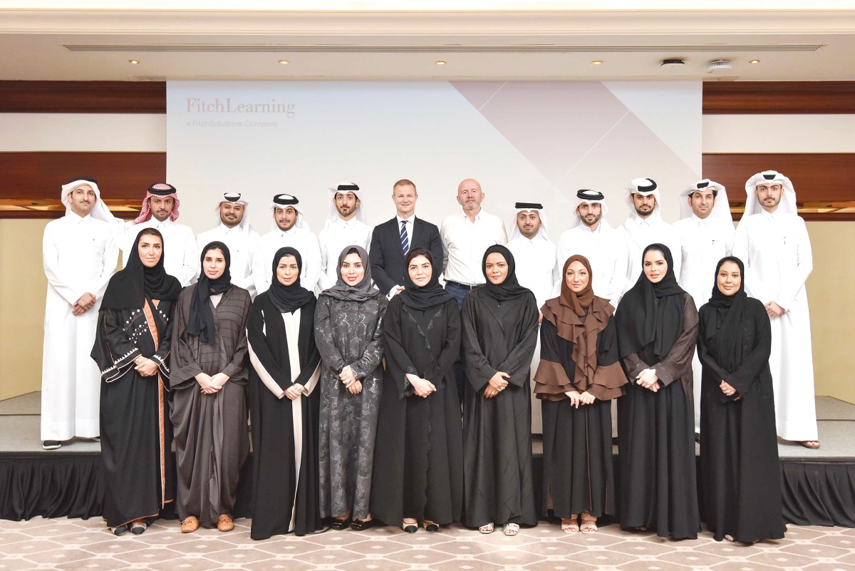 Officials pose for a group photo with participants of the Business of Banking Program.