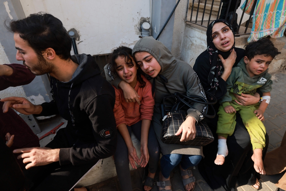 Family members mourn a baby girl killed in an Israeli strike in Rafah in the southern Gaza Strip, in the courtyard of the al-Najjar hospital on December 1, 2023. Photo by MOHAMMED ABED / AFP