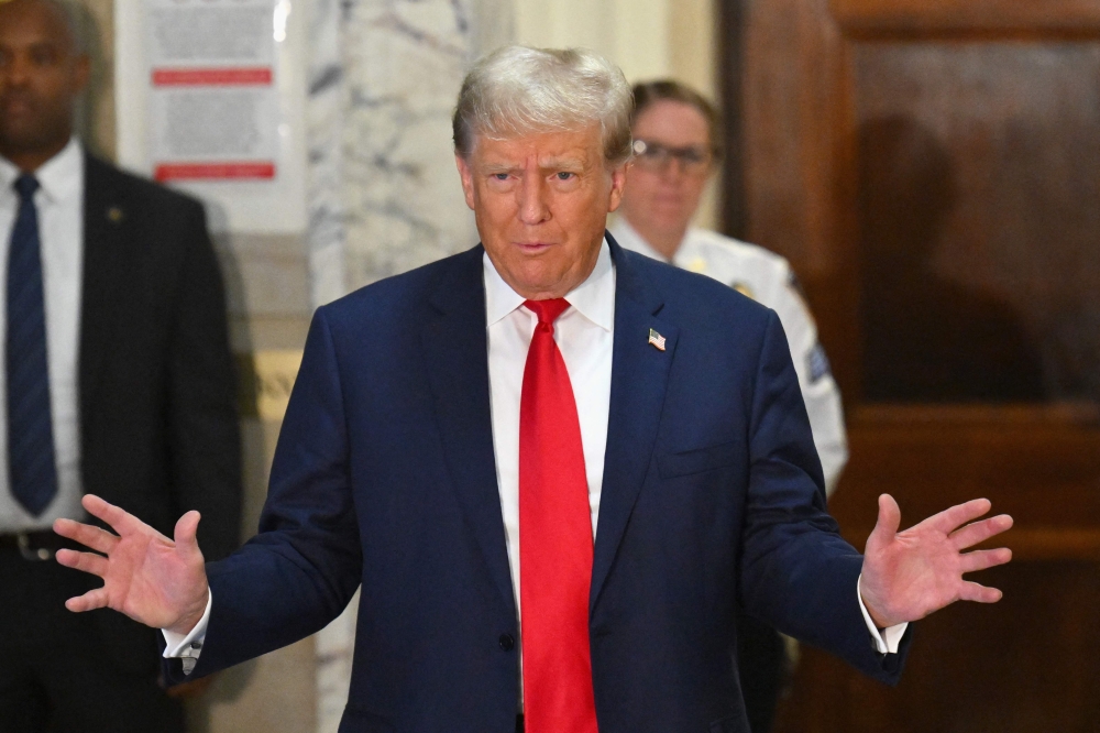 (Files) Former US President Donald Trump speaks to the media during his civil fraud trial in New York on October 4, 2023. (Photo by Angela Weiss / AFP)